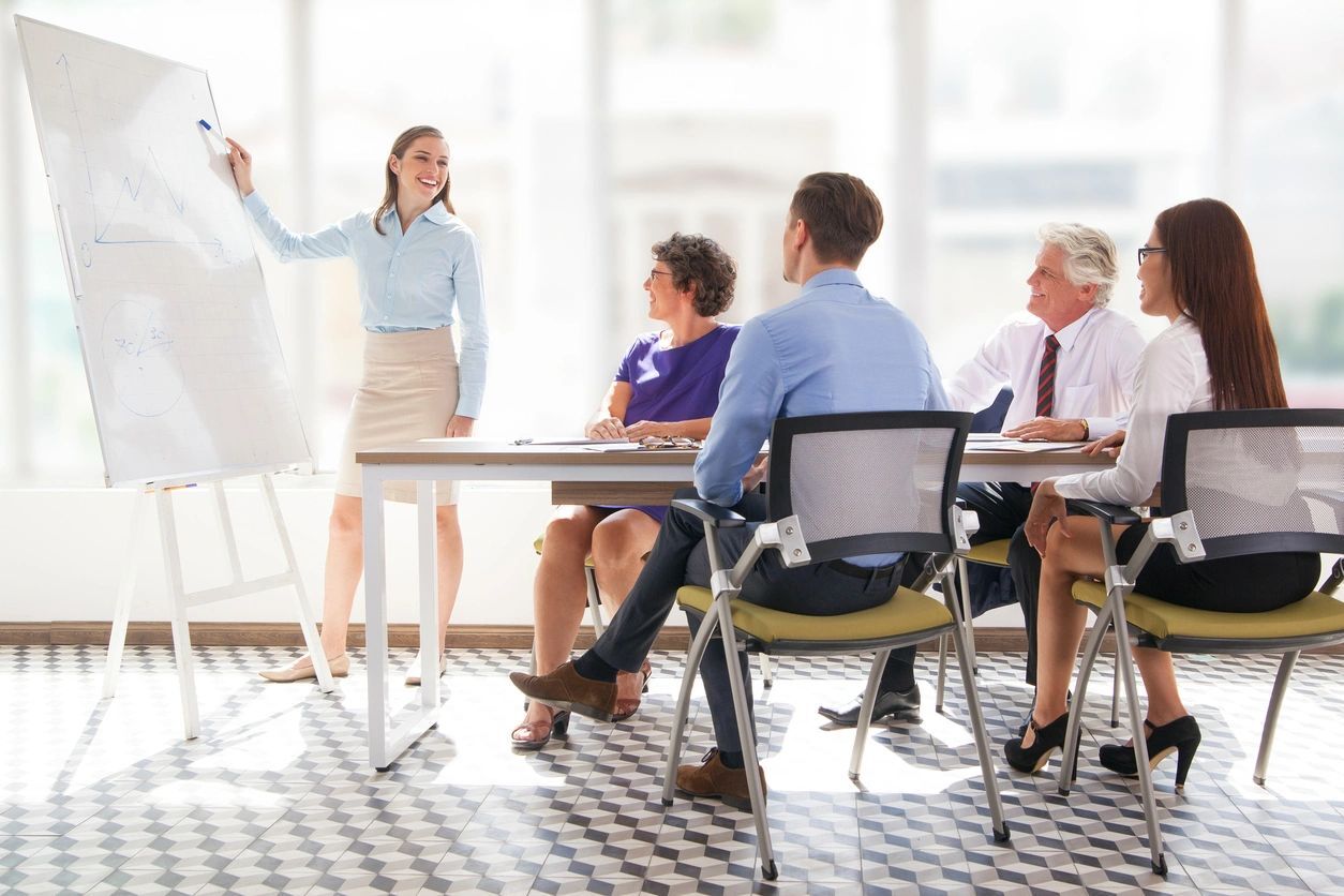 a woman giving a presentation in a meeting